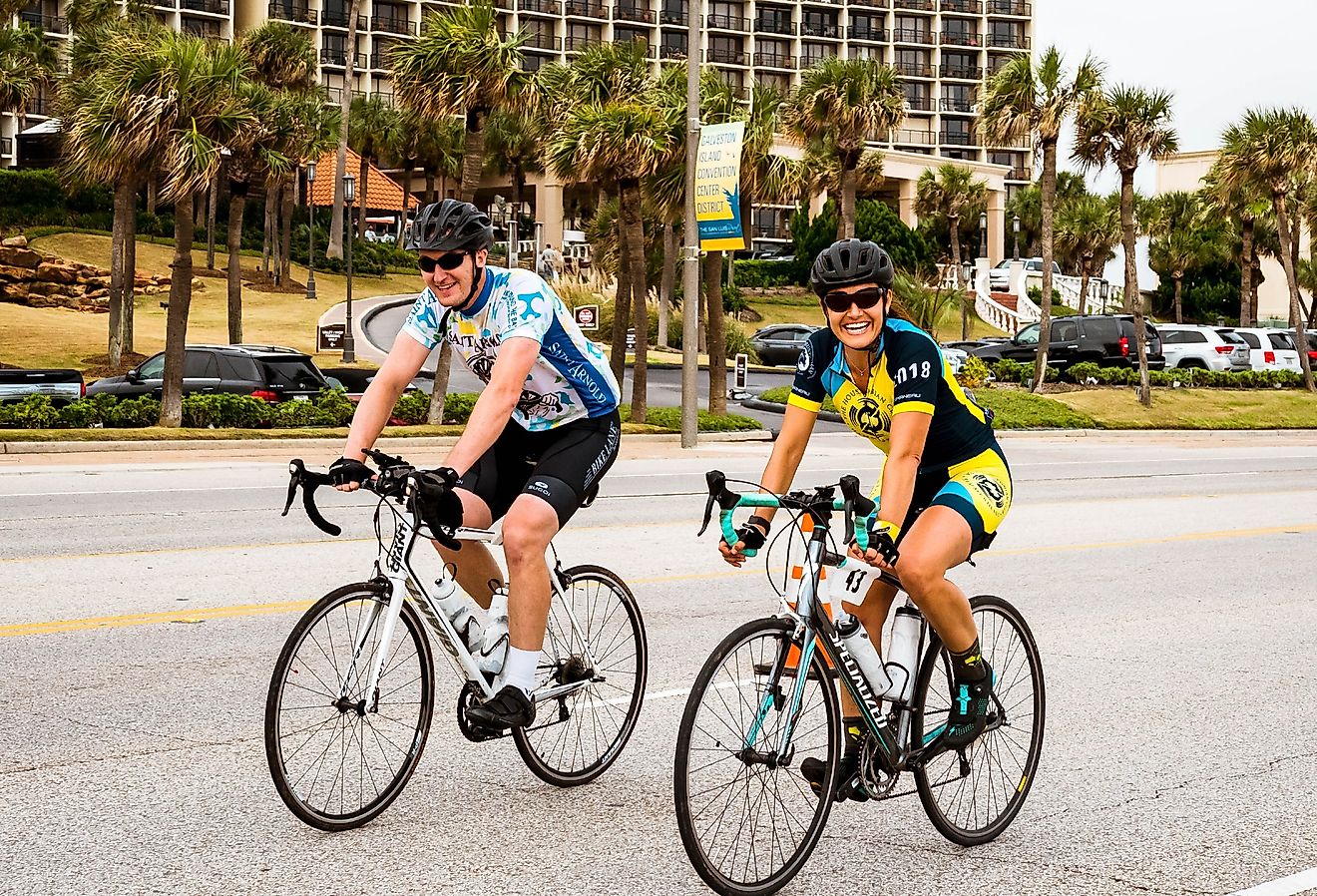 Cyclists ride along the seawall while participating in the Bike Around The Bay Benefit ride in Galveston, Texas. Image credit Mark Taylor Cunningham via Shutterstock