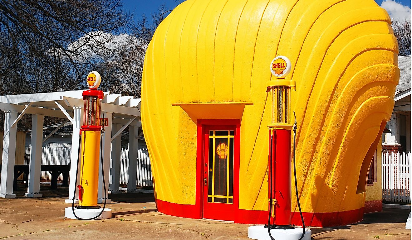 A vintage Shell gas station is shaped like a yellow scallop shell. Editorial credit: James Kirkikis / Shutterstock.com