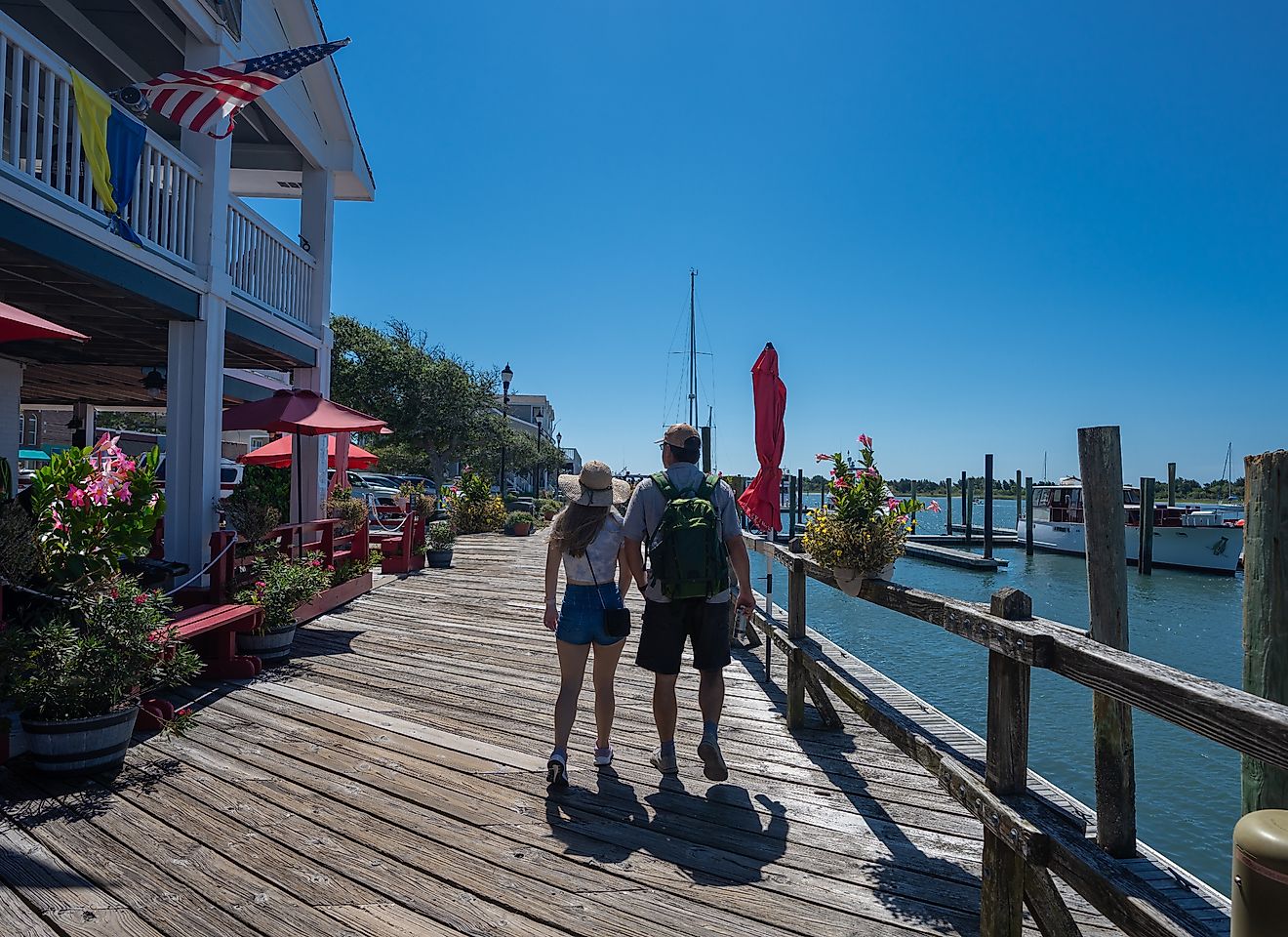 A couple enjoying a summer walk along the waterfront boardwalk in Beaufort, North Carolina.