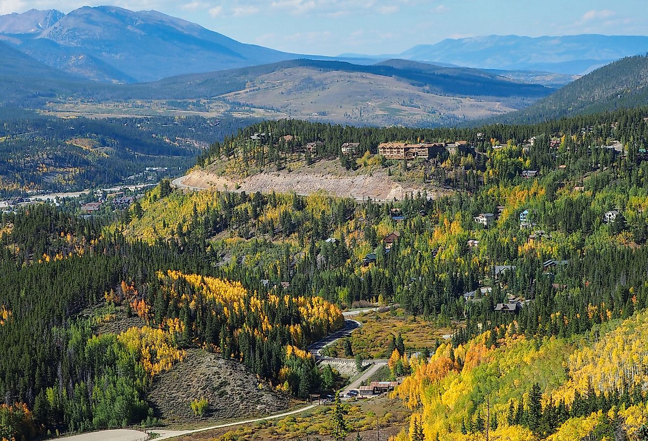 Looking out over Breckenridge, distant mountains, and changing aspen trees on a beautiful, sunny fall day in Colorado.