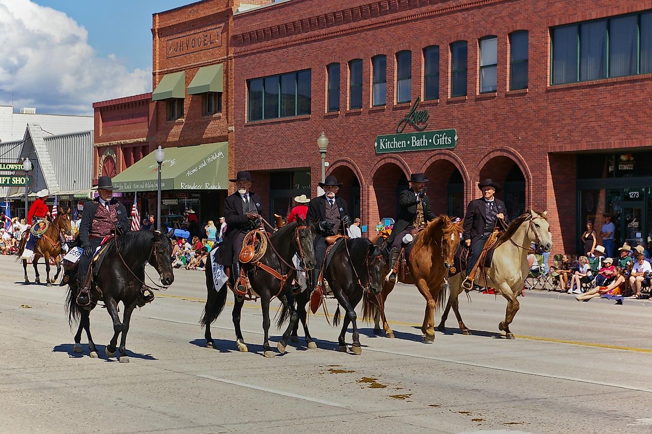 Four riders dressed in black depicting Wyatt Earp, Virgil Earp, Morgan Earp, and Doc Holliday participate in the Independence Day Parade in Cody, Wyoming, USA. Editorial credit: Harald Schmidt / Shutterstock.com