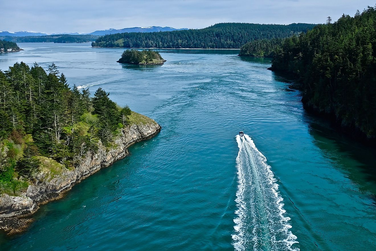 Boat in the ocean among islands. Deception Pass State Park near Anacortes WA