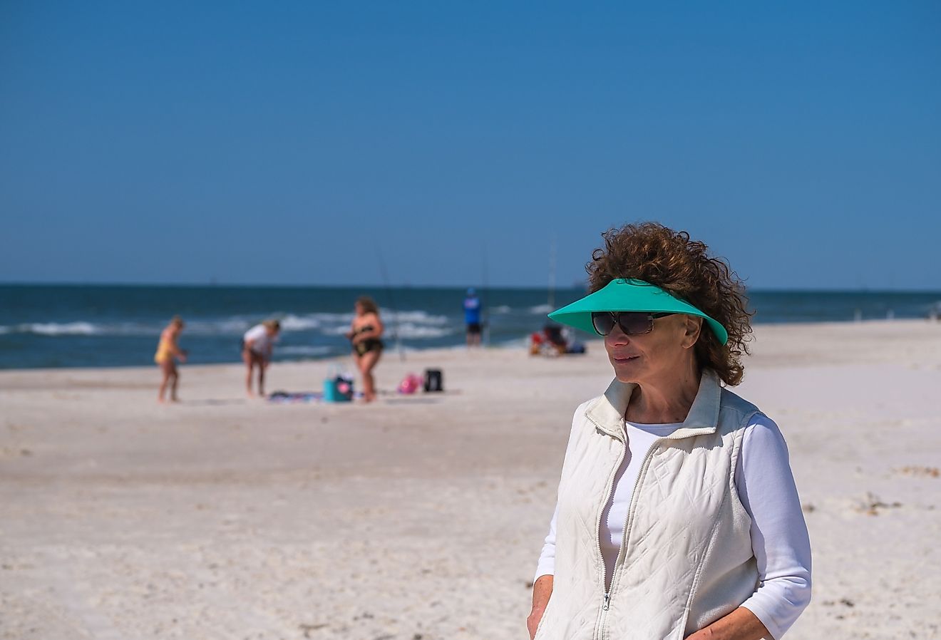 Senior woman on the beach of Gulf Shores, Alabama on a sunny day. Image credit William A. Morgan via Shutterstock.