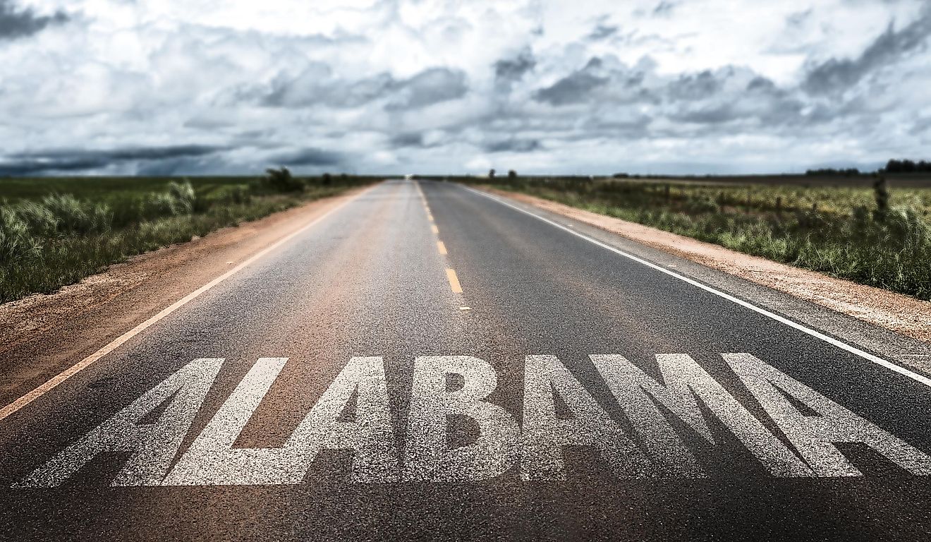 Highway with the word, ALABAMA and dark clouds in the sky.