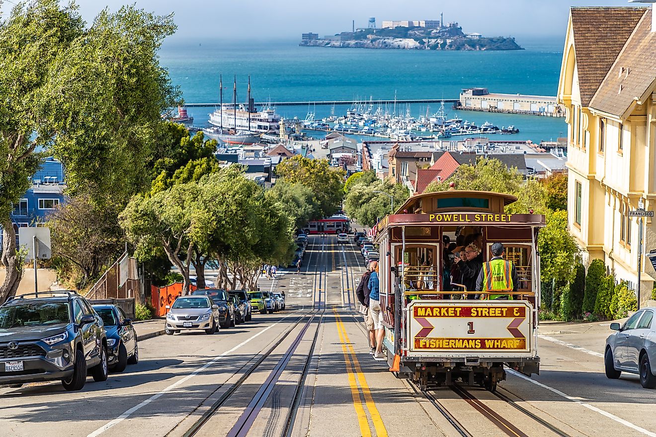 The Cable car tram and Alcatraz prison island on a background in San Francisco, California, via Sergii Figurnyi / Shutterstock.com