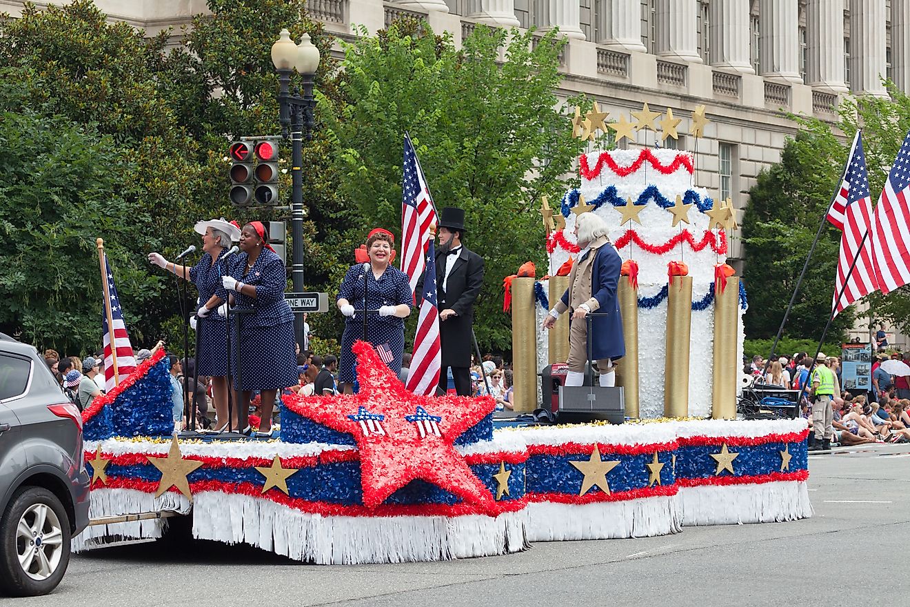 People performing atop a moving patriotic stage during the Fourth of July Parade in Washington, D.C. Editorial credit: Roberto Galan / Shutterstock.com