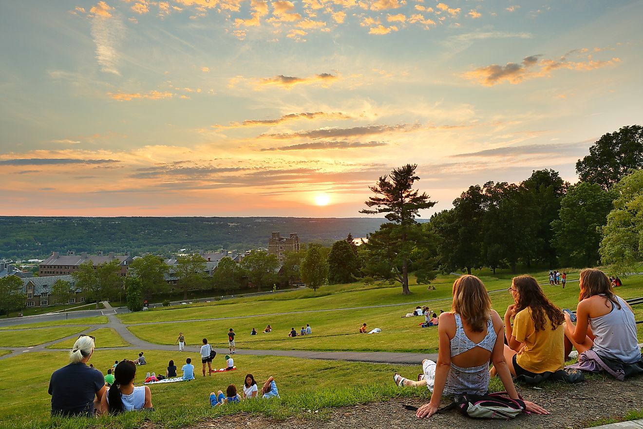 Students watching sunset at Libe Slope on the campus of Cornell University, Ithaca, New York. Editorial credit: Jay Yuan / Shutterstock.com