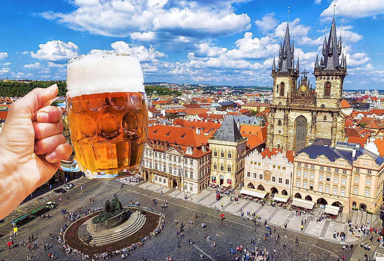 Mug of beer on the background of the Old Town Square in Prague, Czechia.