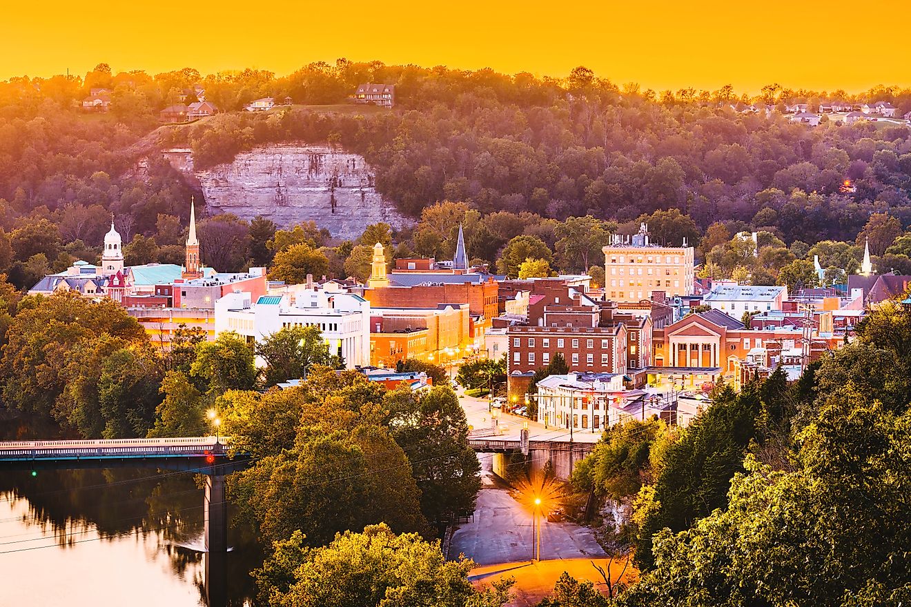 The town skyline of Frankfort, Kentucky, at dusk, with the Kentucky River winding through the scene.