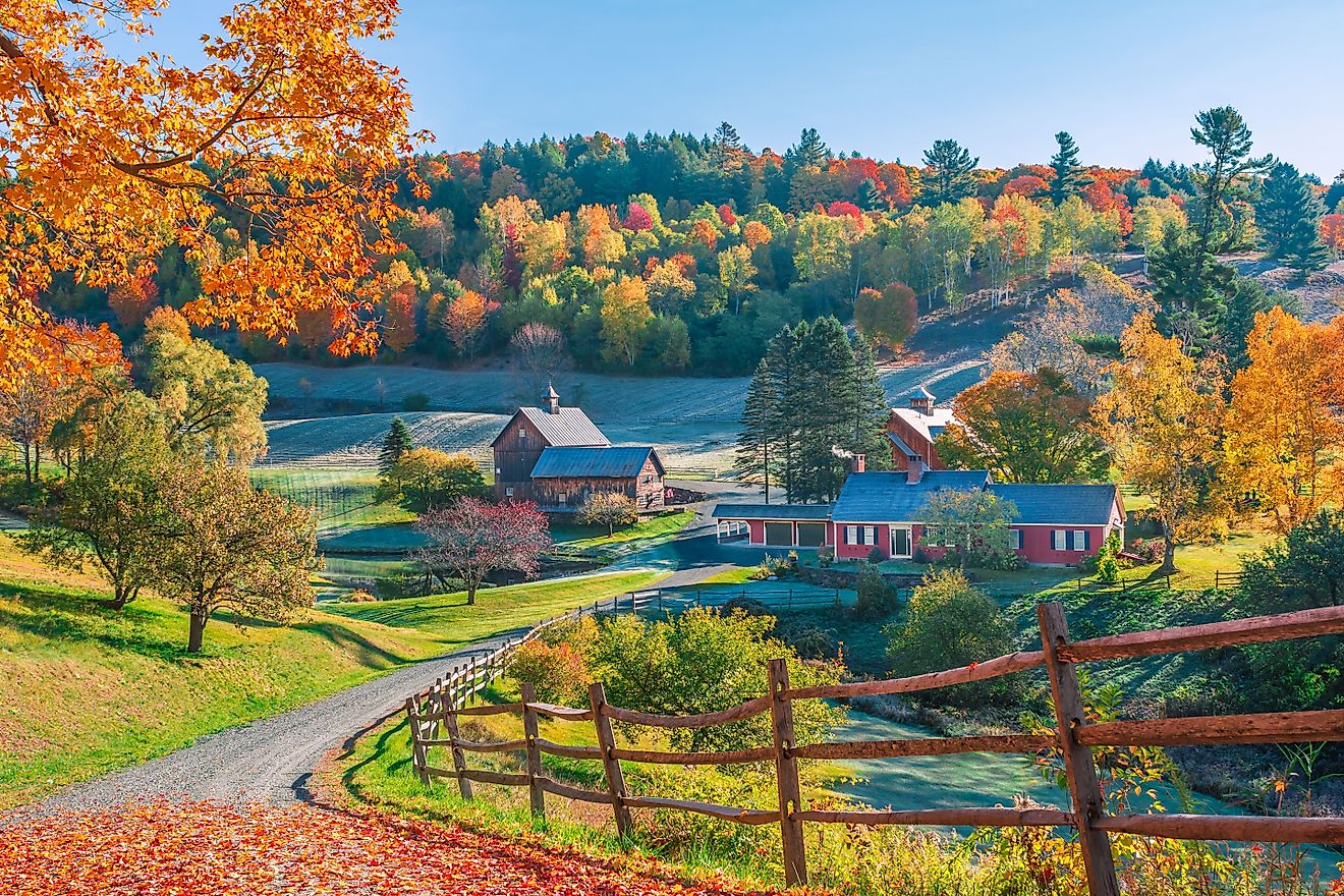 Early autumn foliage scene of houses in the mountains of Woodstock, Vermont.