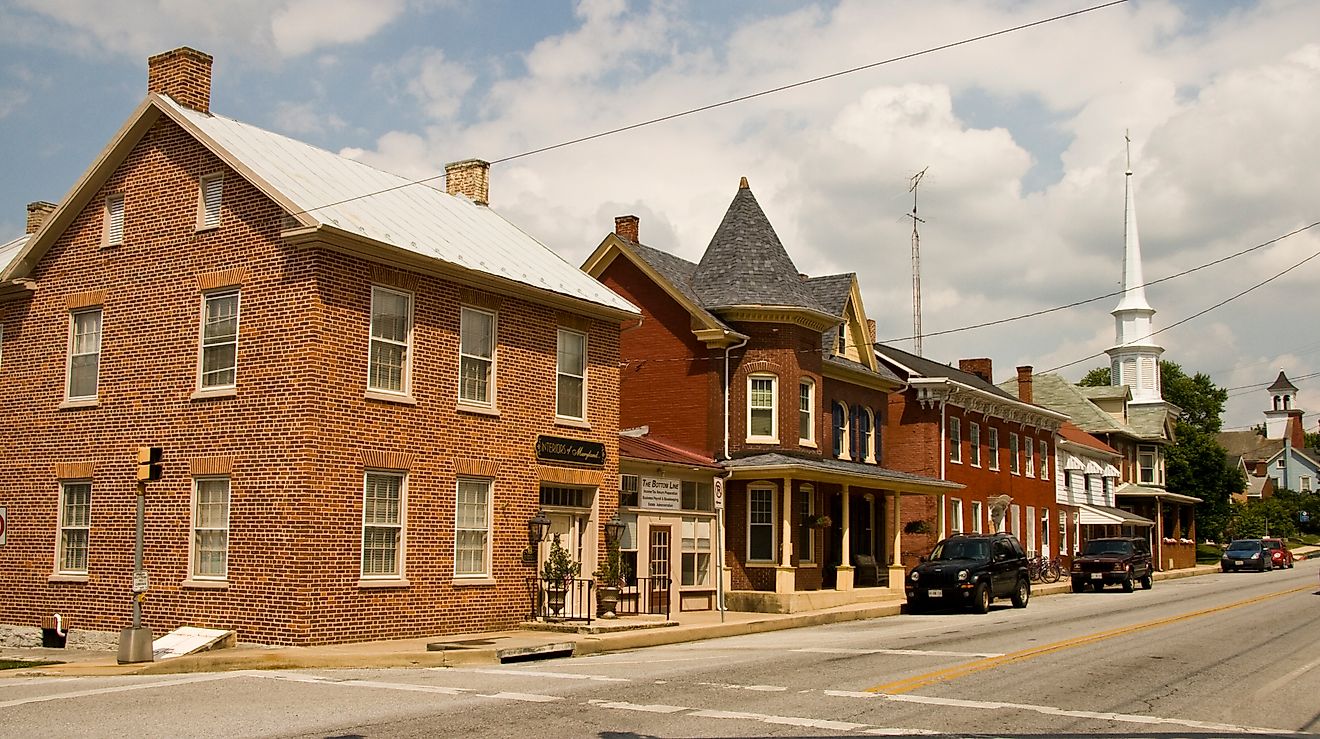 Street view of downtown Funkstown, Maryland, featuring historic brick buildings, small businesses, and tree-lined sidewalks. By Acroterion, CC BY-SA 3.0, https://commons.wikimedia.org/w/index.php?curid=7275466