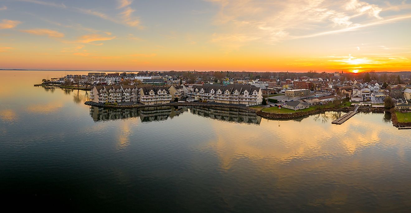 Aerial sunset panorama of Havre de Grace, Maryland, with an orange sky and clouds reflecting on the Susquehanna River and Chesapeake Bay.