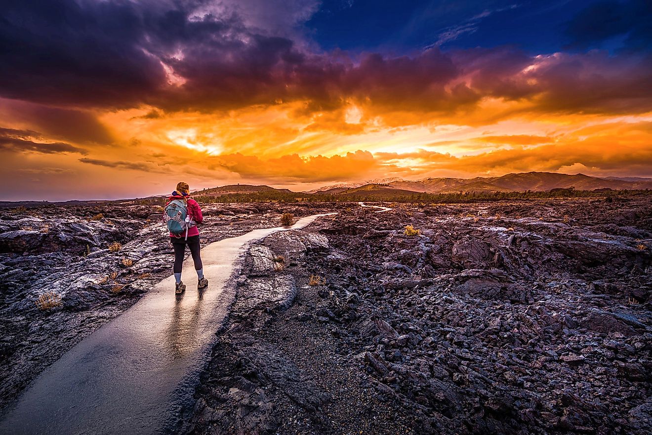 Hiker with a backpack on a trail at Craters of the Moon National Monument in Idaho