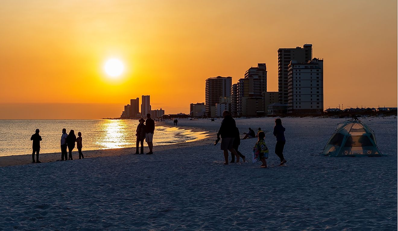 People gathering on the beach to watch the sun set. Gulf Shores is an increasingly popular tourist location. Editorial credit: James.Pintar / Shutterstock.com