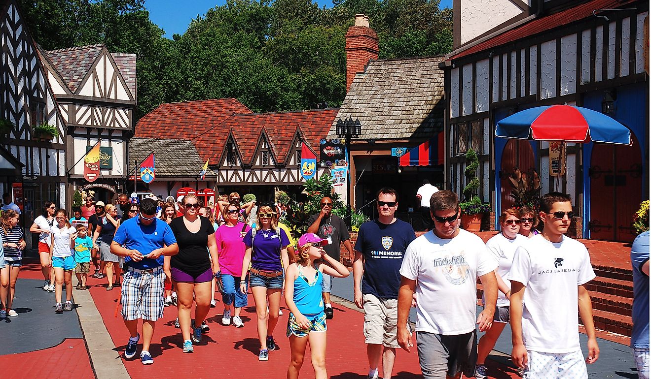 A crowd of people make their way through a recreated Tudor Village in Busch Gardens, in Williamsburg, Virginia. Editorial credit: James Kirkikis / Shutterstock.com