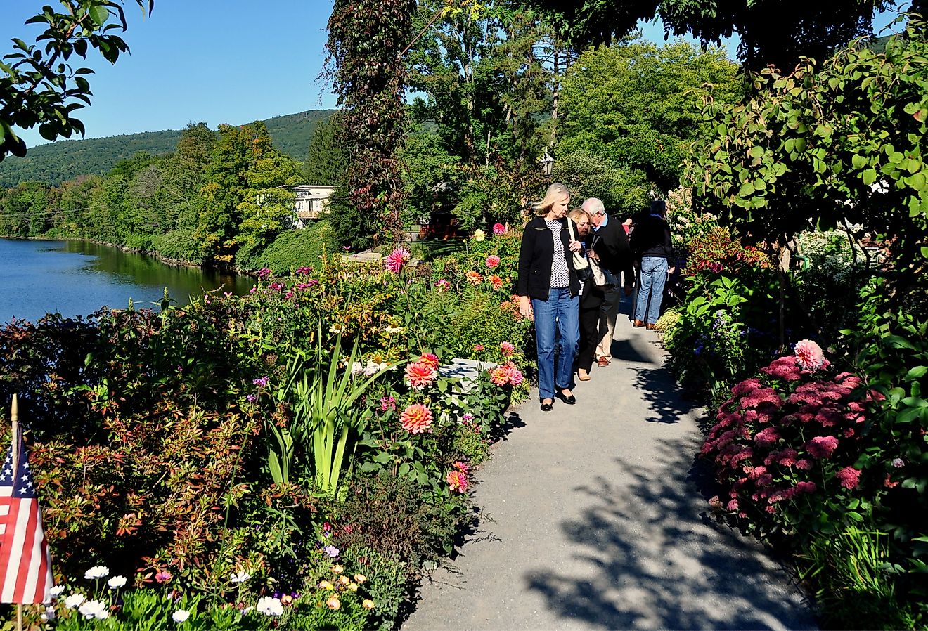 Visitors strolling along the former trolley span now the Bridge of Flowers over the Deerfield River in Shelburne Falls. Image credit LEE SNIDER PHOTO IMAGES via Shutterstock.