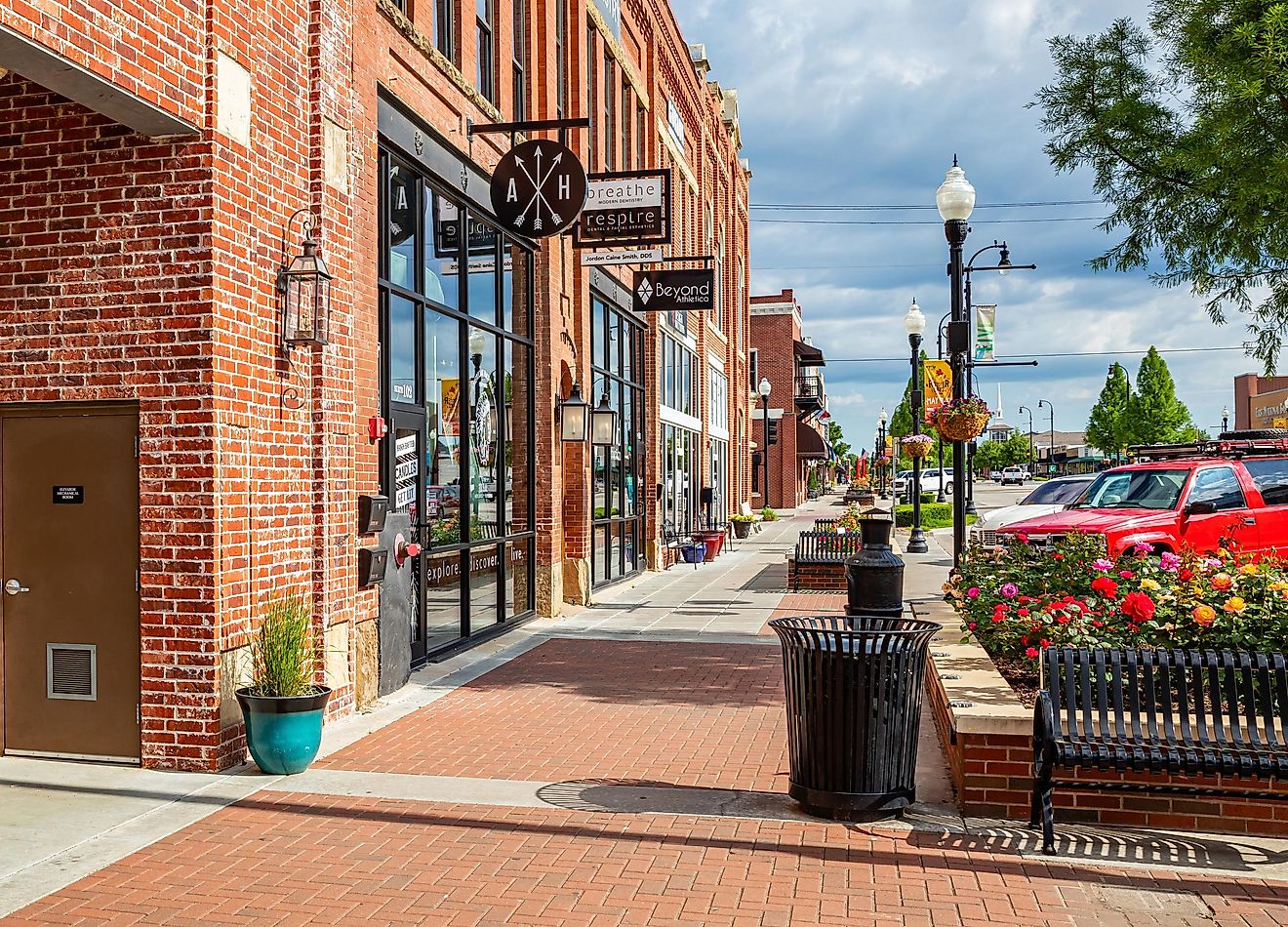 Tulsa, Oklahoma, USA. May 13, 2019. Neighborhood with traditional stores. Brick walls shops with the entrance on the pavement wait for customers a sunny day.