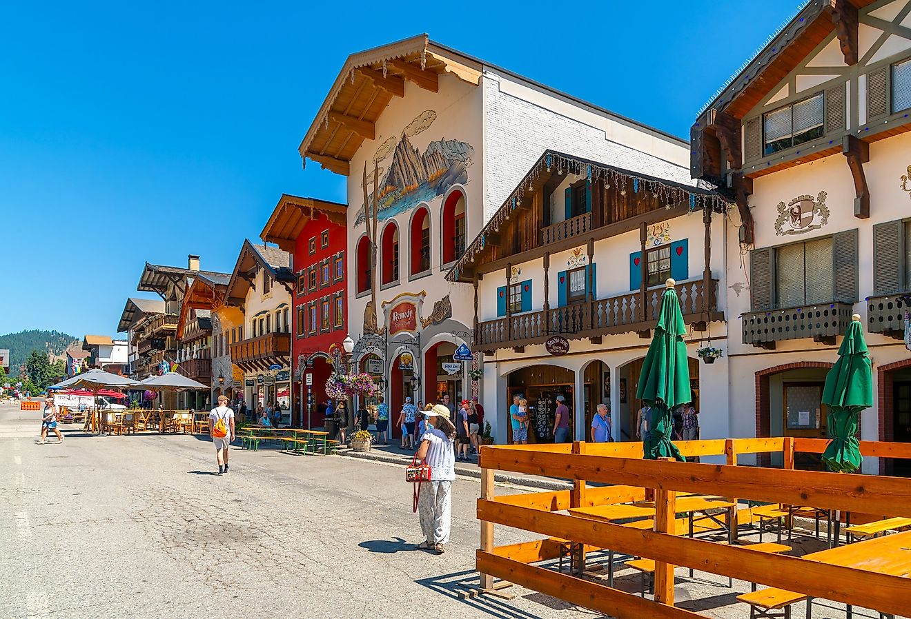 Shops and sidewalk cafes line the quaint Bavarian themed main street of the tourist resort town of Leavenworth, Washington. Image credit Kirk Fisher via Shutterstock