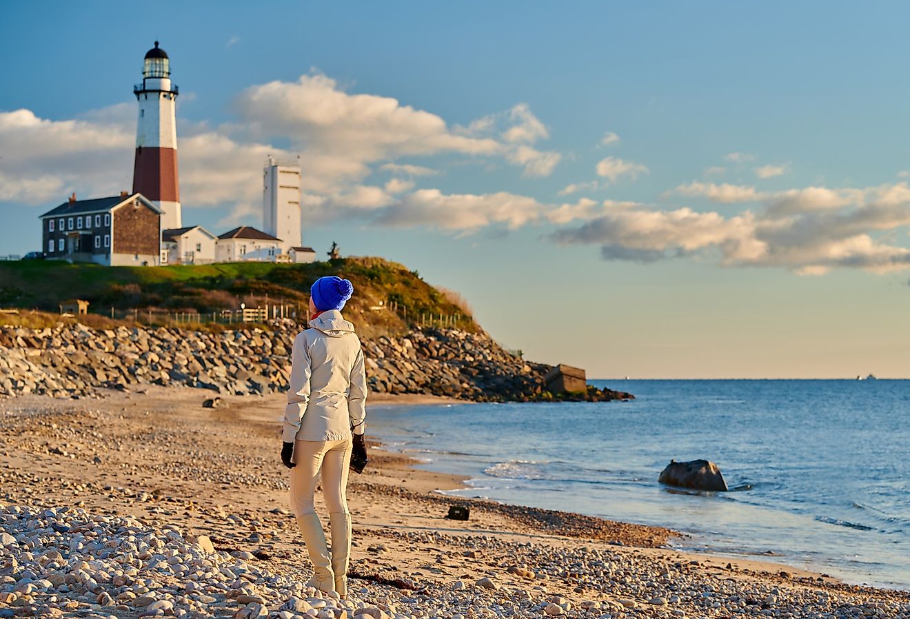 Woman tourist at the beach near Montauk Lighthouse, New York.