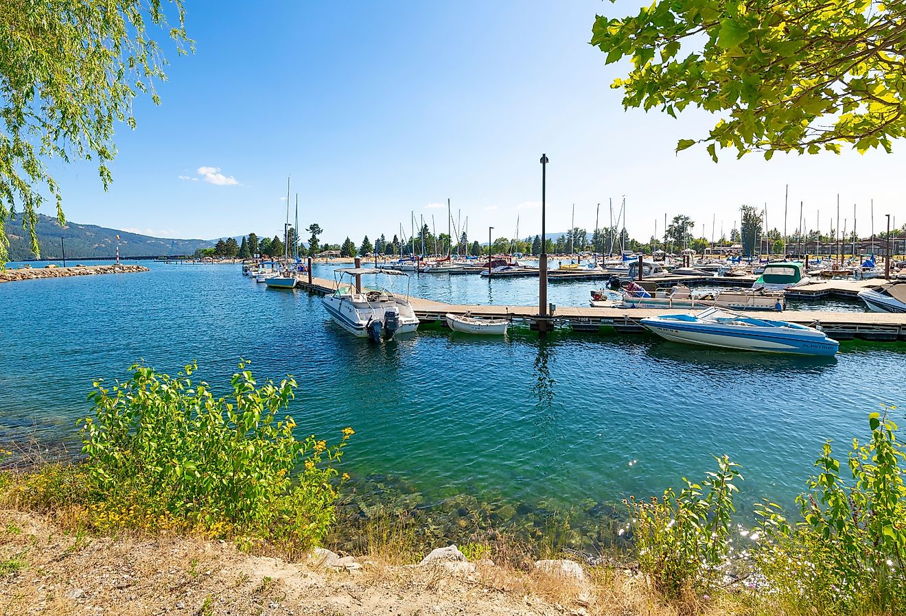 The marina and city beach area of downtown Sandpoint, Idaho, with boats filling the docks on Lake Pend Oreille on a summer day in the Idaho panhandle.