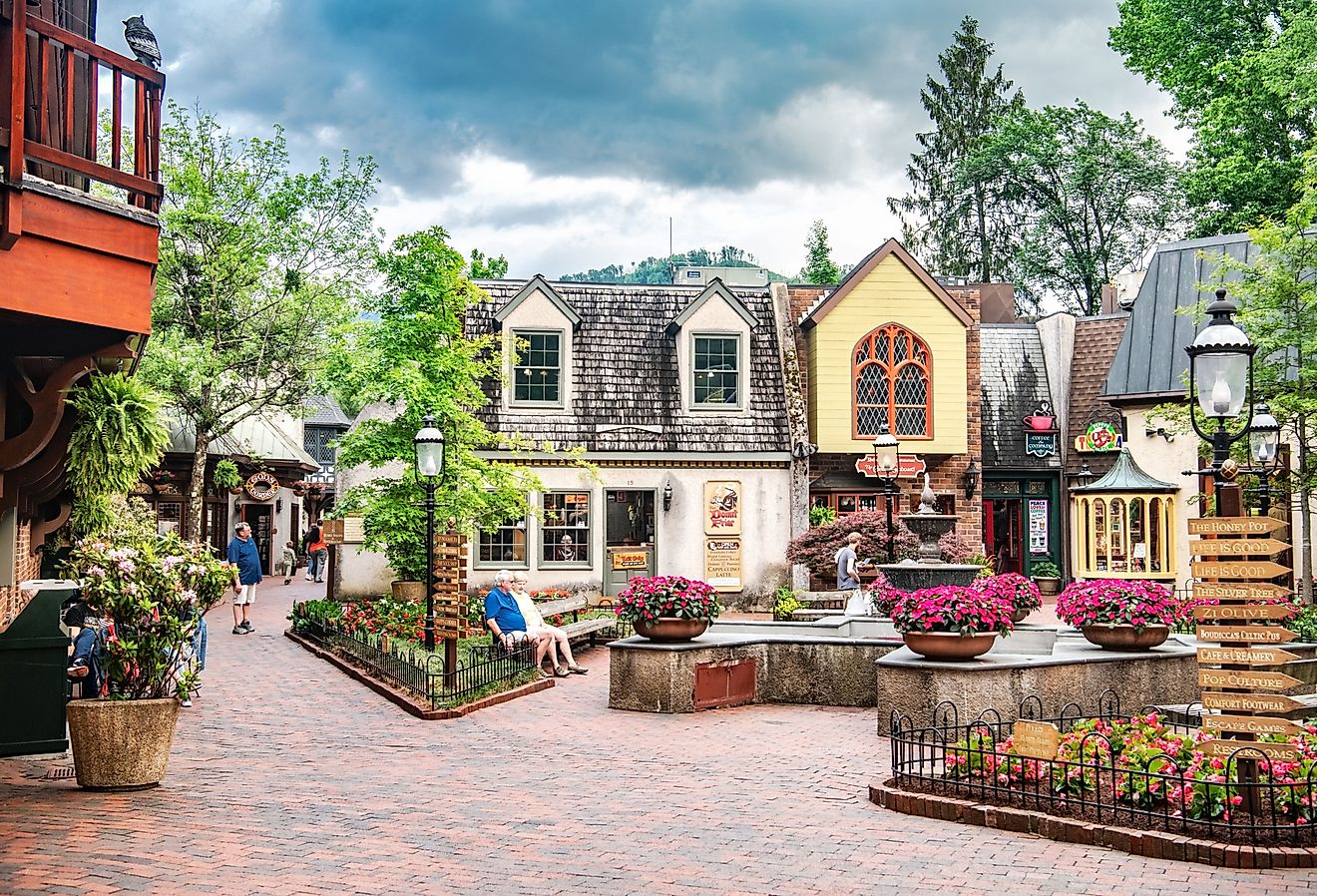 Quaint area of the lovely Gatlinburg, Tennessee with people sitting on a bench. Image credit Kosoff via Shutterstock.