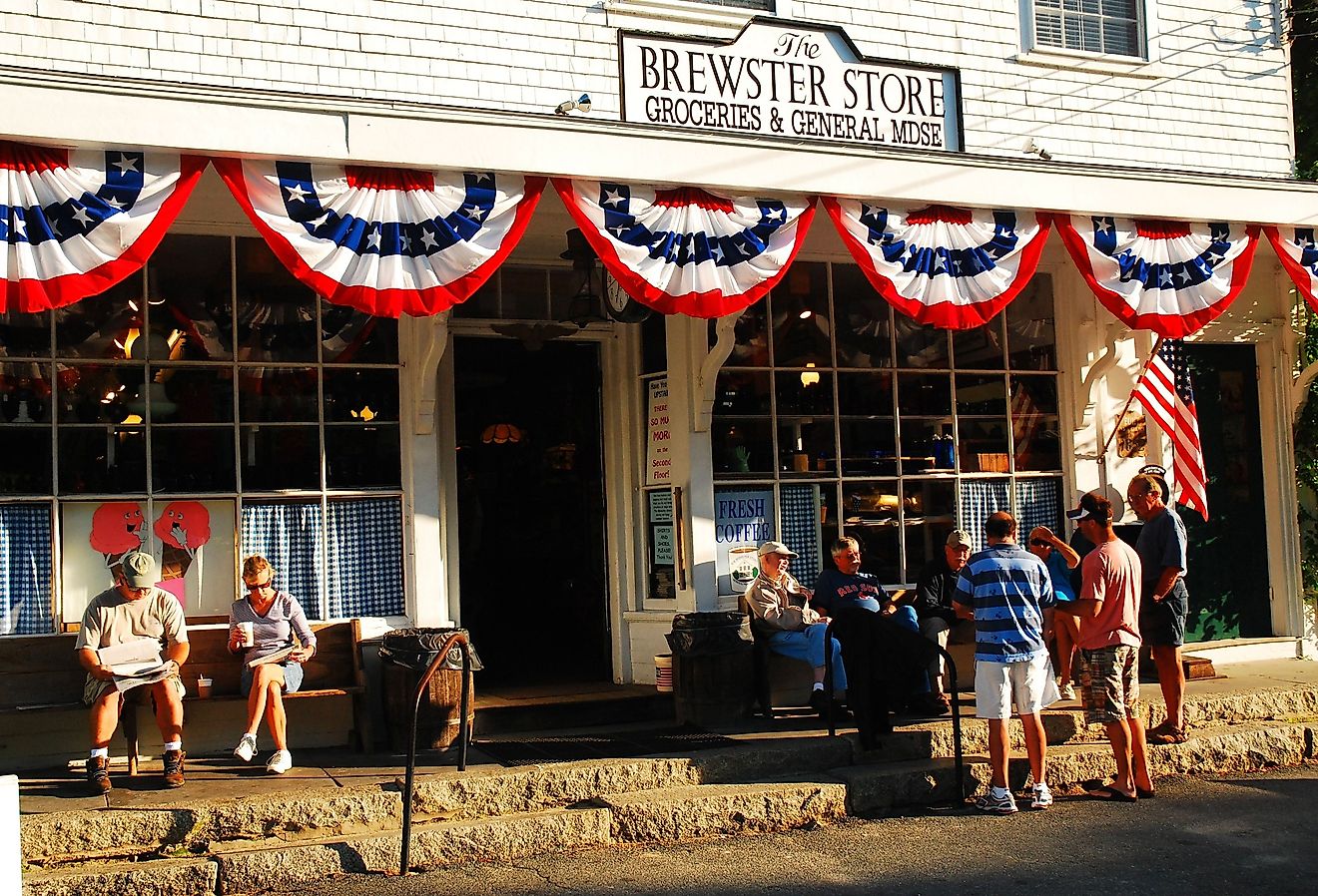 People gather and talk to friends in front of the general store in Brewster, Massachusetts. Image credit James Kirkikis via Shutterstock.