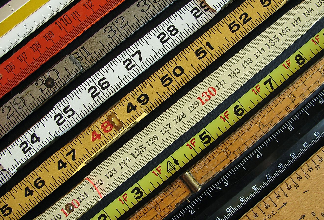 Old rulers both metric and inches, scales and measuring tools represent measurement, metrics, and precision.