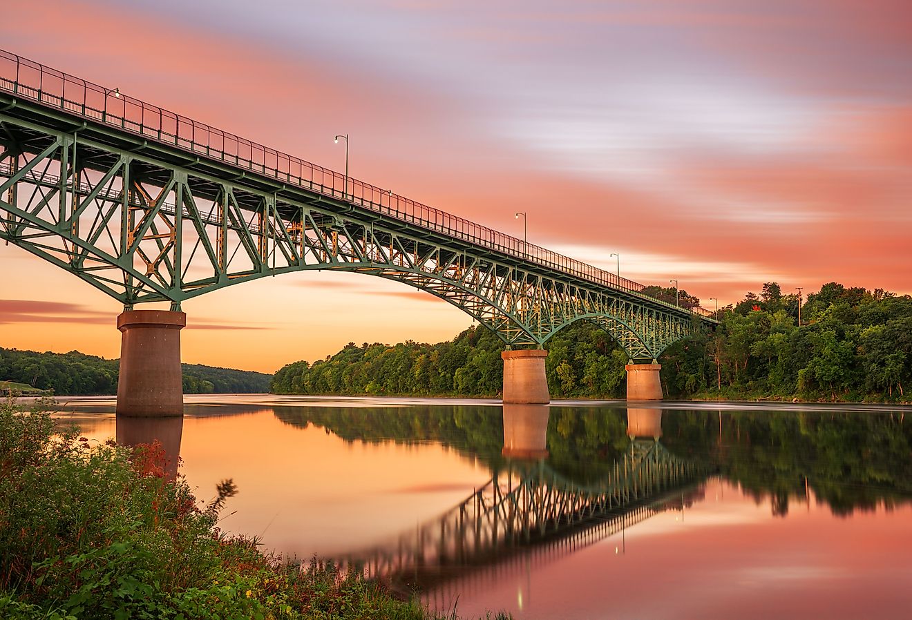 Augusta, Maine view on the Kennebec River with Memorial Bridge at dawn.