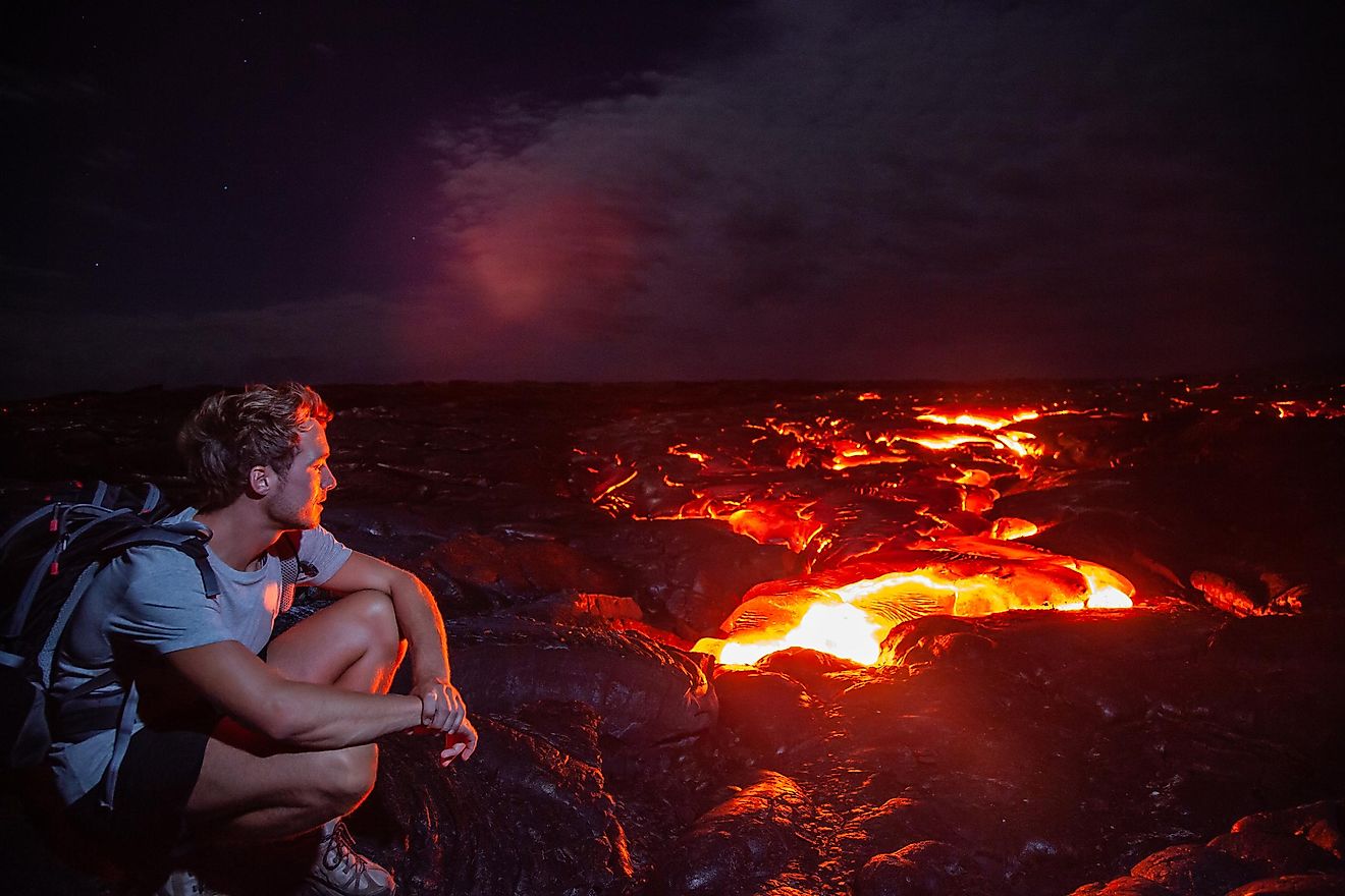 Tourist admiring the spectacular view of a volcano at the Hawaii Volcanoes National Park.