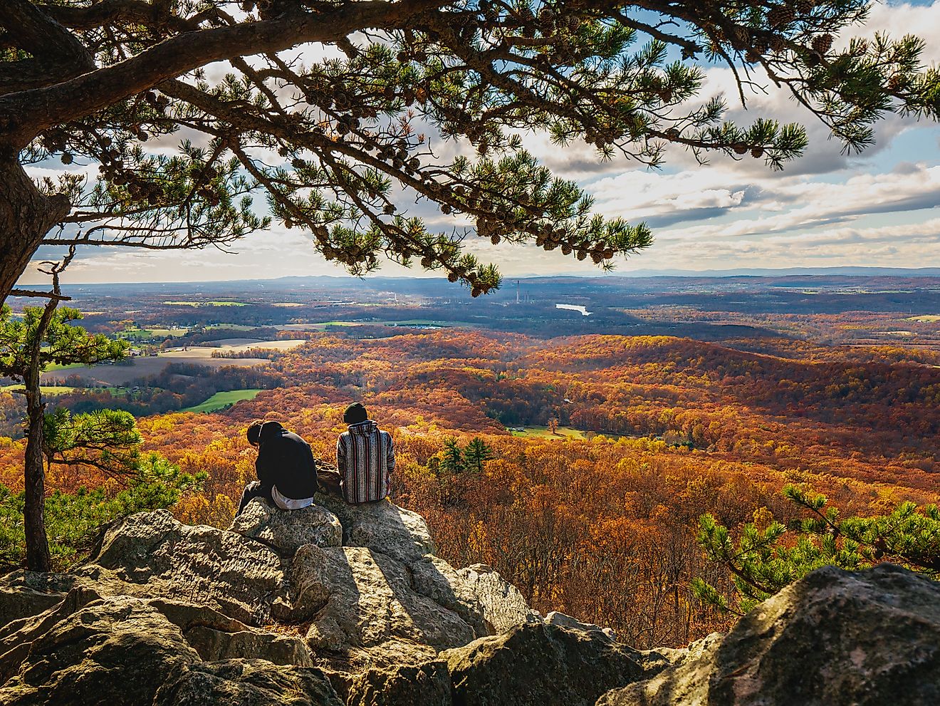 Two people enjoying the view from the Sugarloaf Mountain of Maryland.