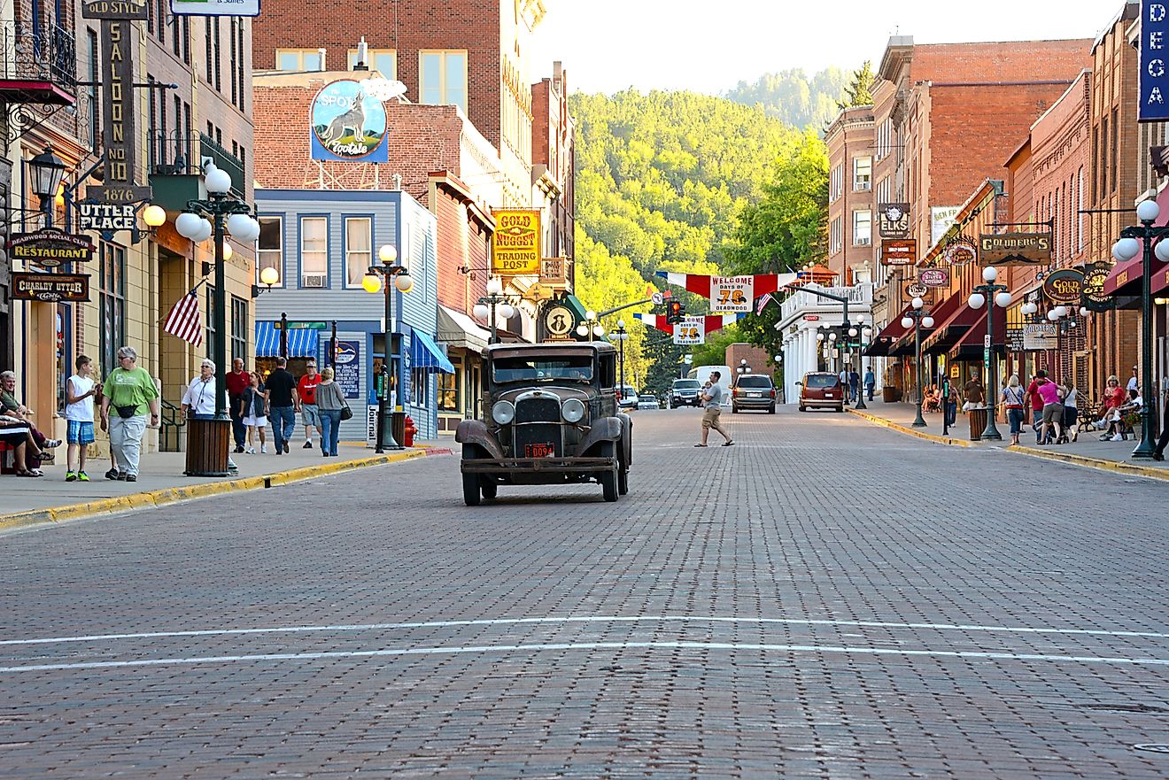 A vintage car approaching the Main Street in Deadwood, South Dakota. Editorial credit: Michael Kaercher / Shutterstock.com.