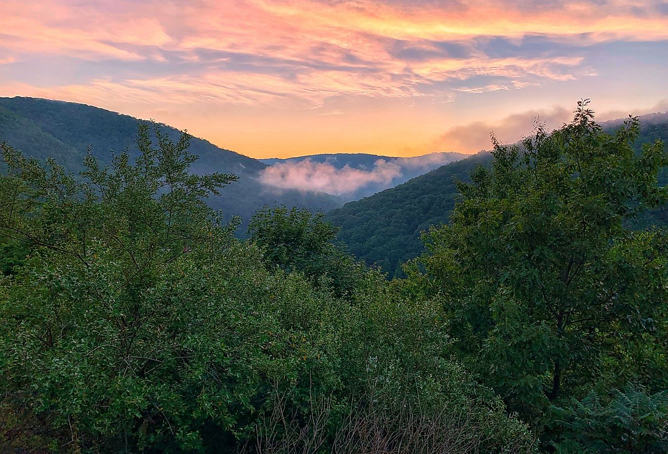 A colorful sunset sky above the cool, cloudy Pocono Mountains in Pennsylvania. Image credit Quinn Kampschroer via Shutterstock. 