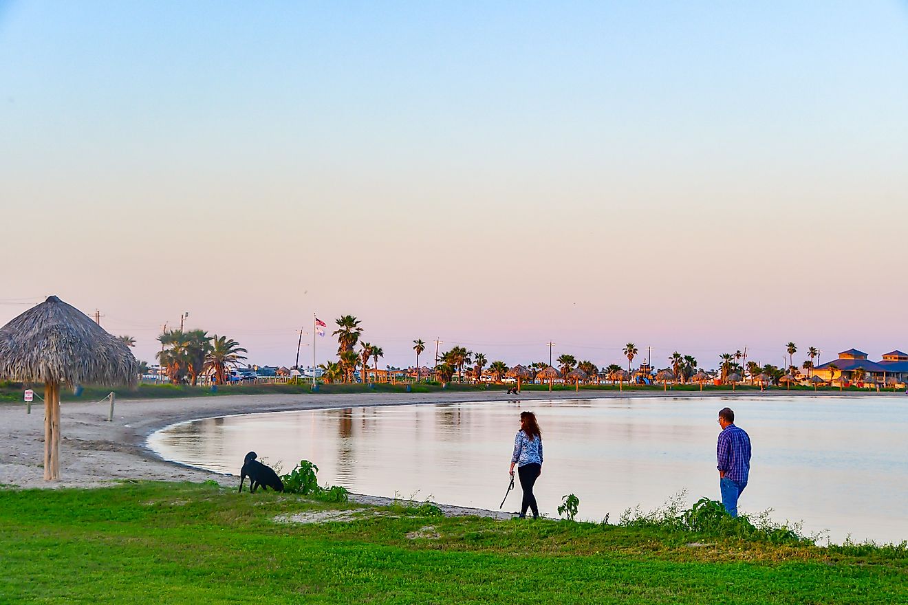 Rockport, Texas: Unidentified people enjoying a beautiful sunset at the beach, via Grossinger / Shutterstock.com