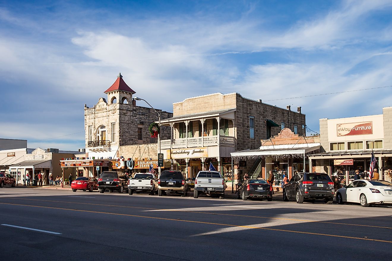 The Main Street in Fredericksburg, Texas, also known as "The Magic Mile", with retail stores and people walking, via Moab Republic / Shutterstock.com