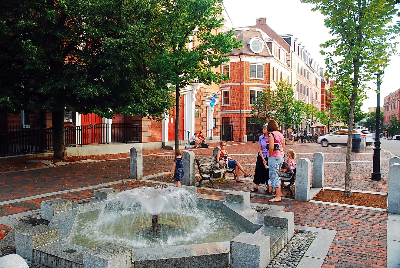 Summer evening near a fountain, talking to friends in downtown Portsmouth, New Hampshire. Editorial credit: James Kirkikis / Shutterstock.com