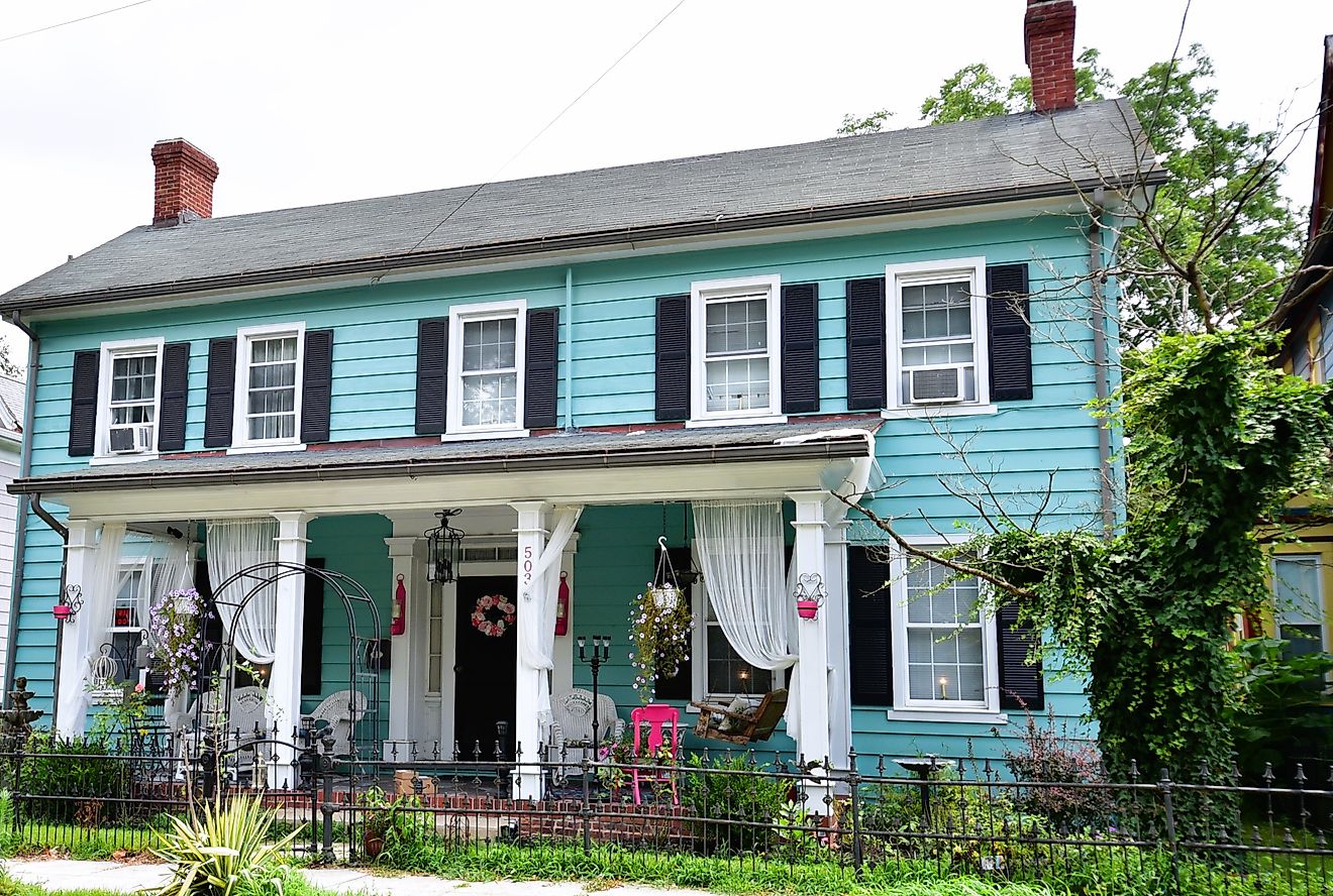 A beautifully restored colonial-style home, painted blue with black shutters, in the historical district of downtown Laurel, Delaware. Editorial credit: Dee Dalasio / Shutterstock.com