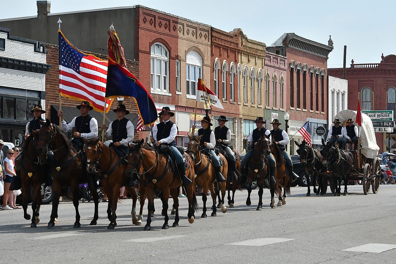 Members of the Fort Riley Commanding General's Mounted Color Guard ride in the Washunga Days Parade in Council Grove, Kansas. Editorial credit: mark reinstein / Shutterstock.com