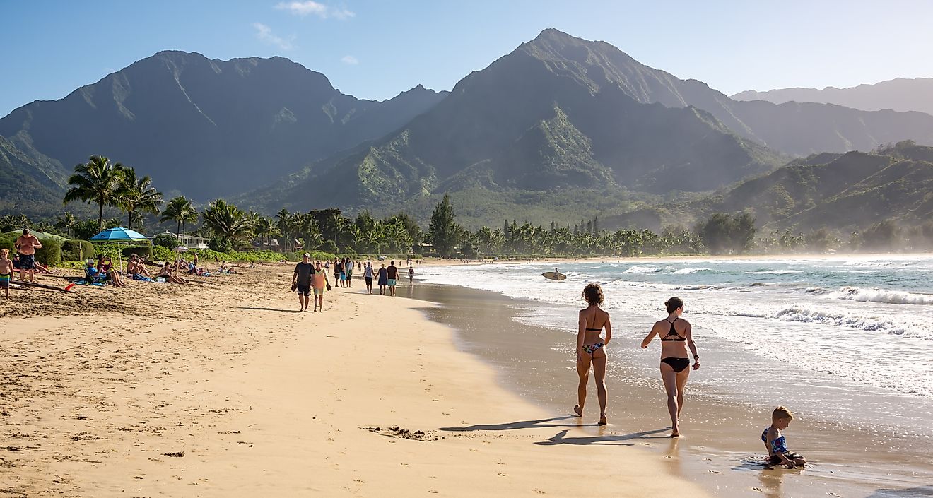 People enjoying the sun and views on the beach at Hanalei Bay on the north shore of Kauai, Hawaii. Editorial credit: Chase Clausen / Shutterstock.com