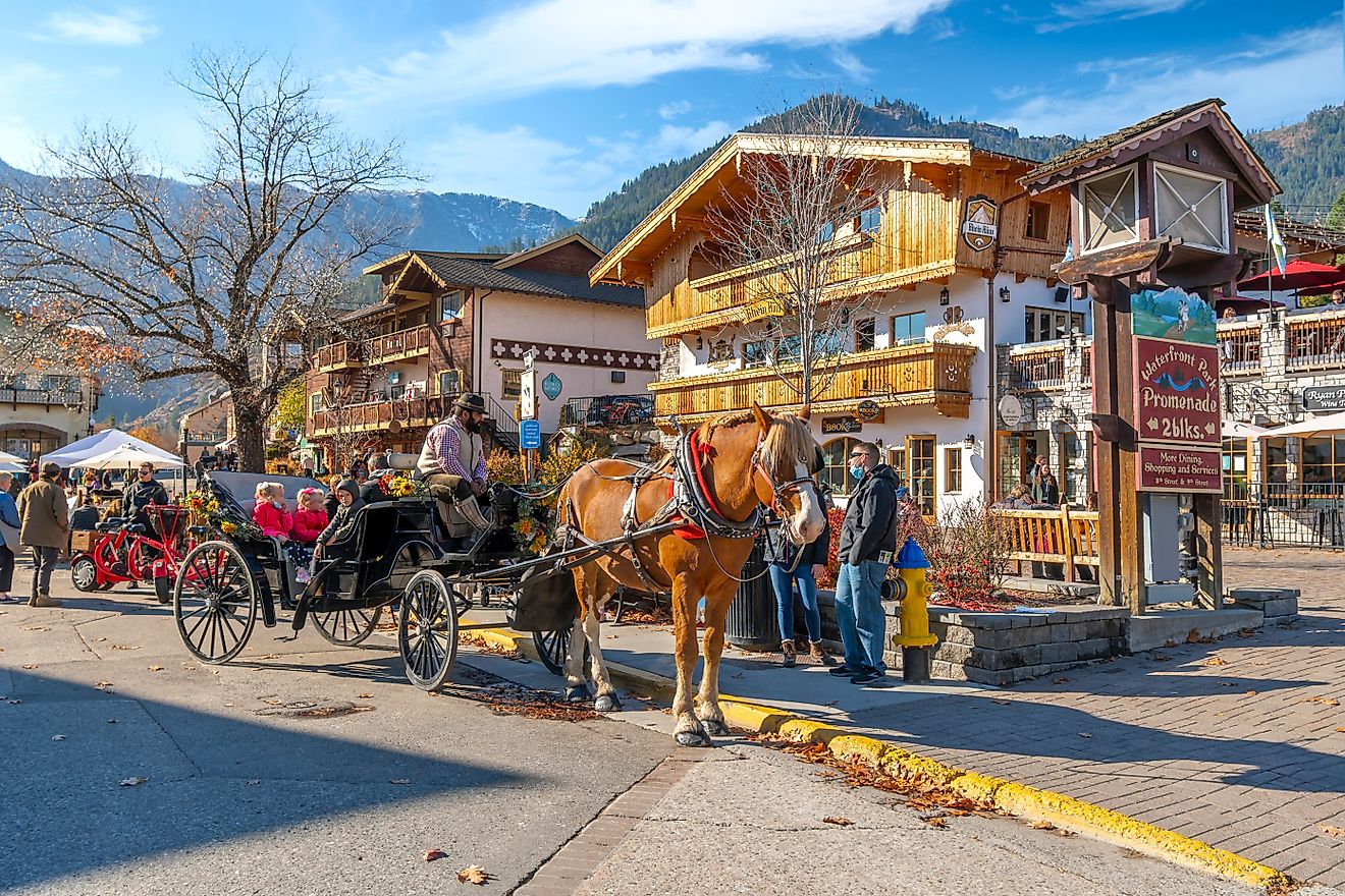 A horse-drawn carriage carrying tourists through the colorful Bavarian-themed village of Leavenworth, Washington. Editorial credit: Kirk Fisher / Shutterstock.com