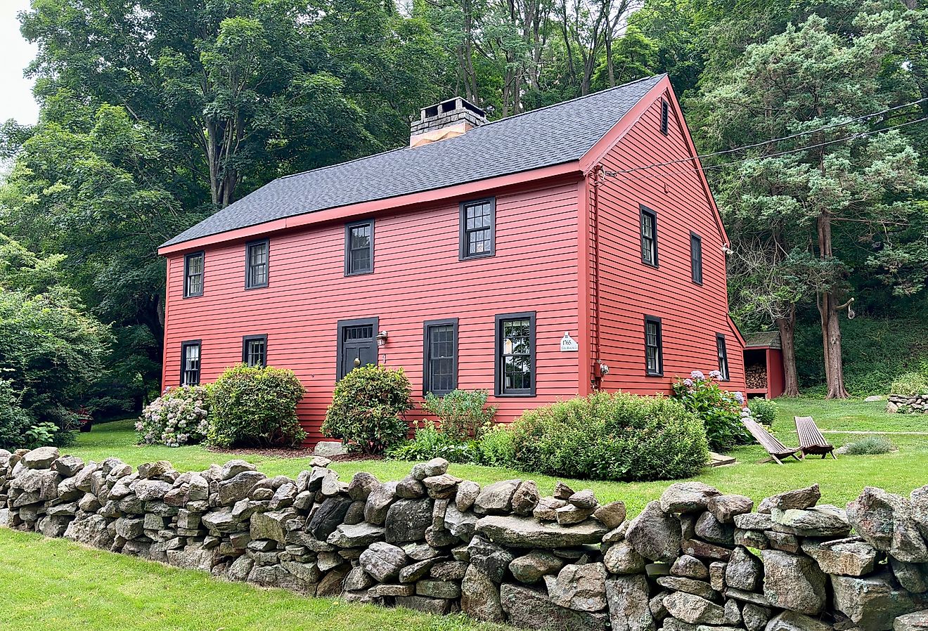 Vintage, red house with stone wall in foreground. Summer, nature scene in Guilford, Connecticut. Image credit  Rachel Rose Boucher via Shutterstock.