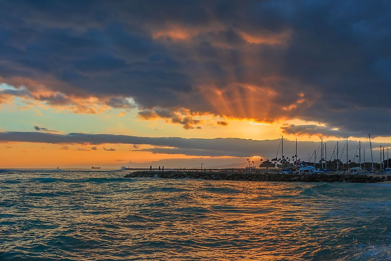 Stunning sunset with sunbeams shinning through storm clouds in Waipahu, Oahu, Hawaii. 