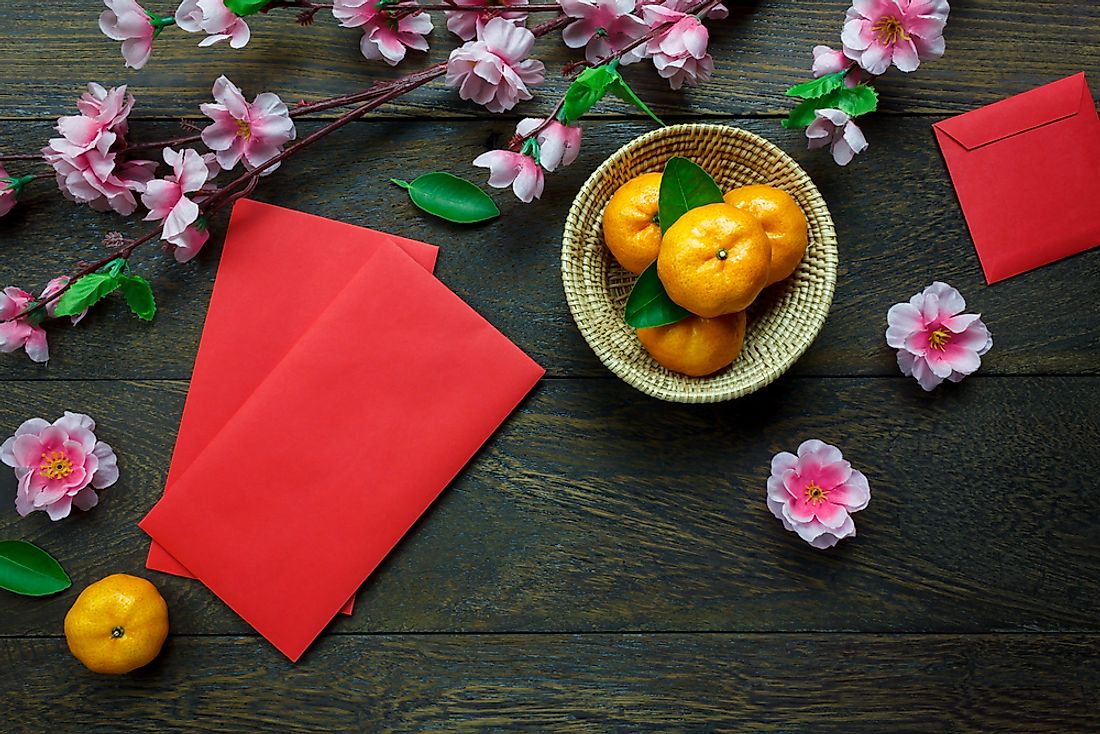 Lunar New Year festivities include oranges and red envelopes. 