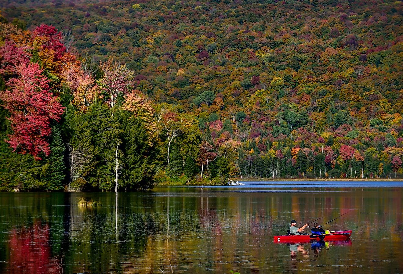 Kayakers on Lake Eden, Vermont, in the fall. Image credit T photography via Shutterstock.