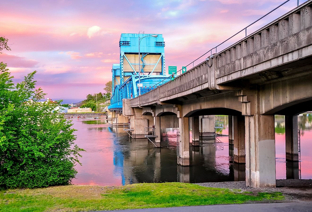 Historic Lewiston, Idaho with the Clarkston Blue Bridge against a pink sky.