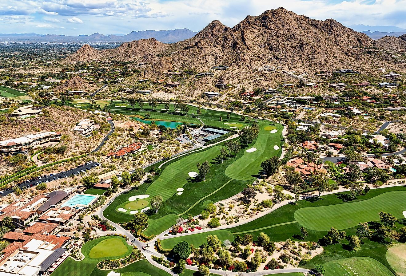 Aerial view from above a scenic golf course in Paradise Valley, Arizona looking to the northeast at Mummy Mountain and the McDowell Mountains in the distance