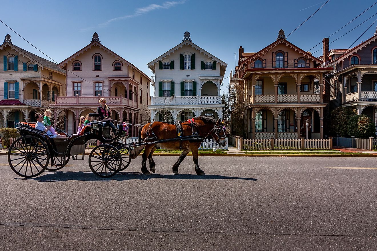 A horse-drawn carriage carrying tourists passes by a row of Victorian "gingerbread" houses in Cape May, New Jersey. Editorial credit: Steve Rosenbach / Shutterstock.com