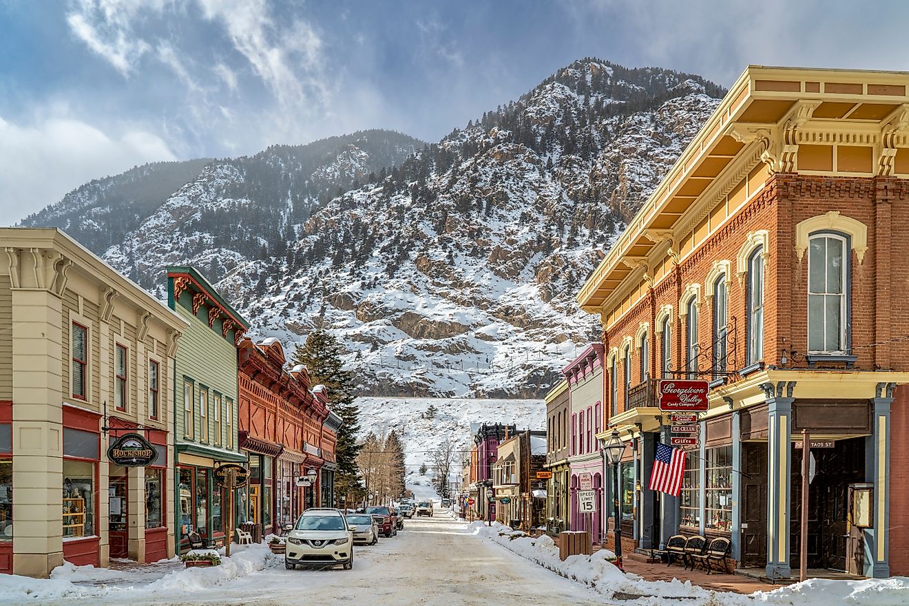 Rustic buildings lined along 6th Street in Georgetown, Colorado, with mountains in the background. Editorial credit: marekuliasz / Shutterstock.com