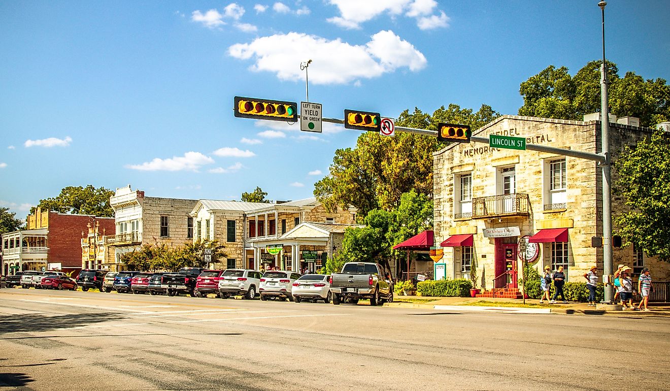 The Main Street in Fredericksburg, Texas, also known as "The Magic Mile," with retail stores and people walking. Editorial credit: ShengYing Lin / Shutterstock.com