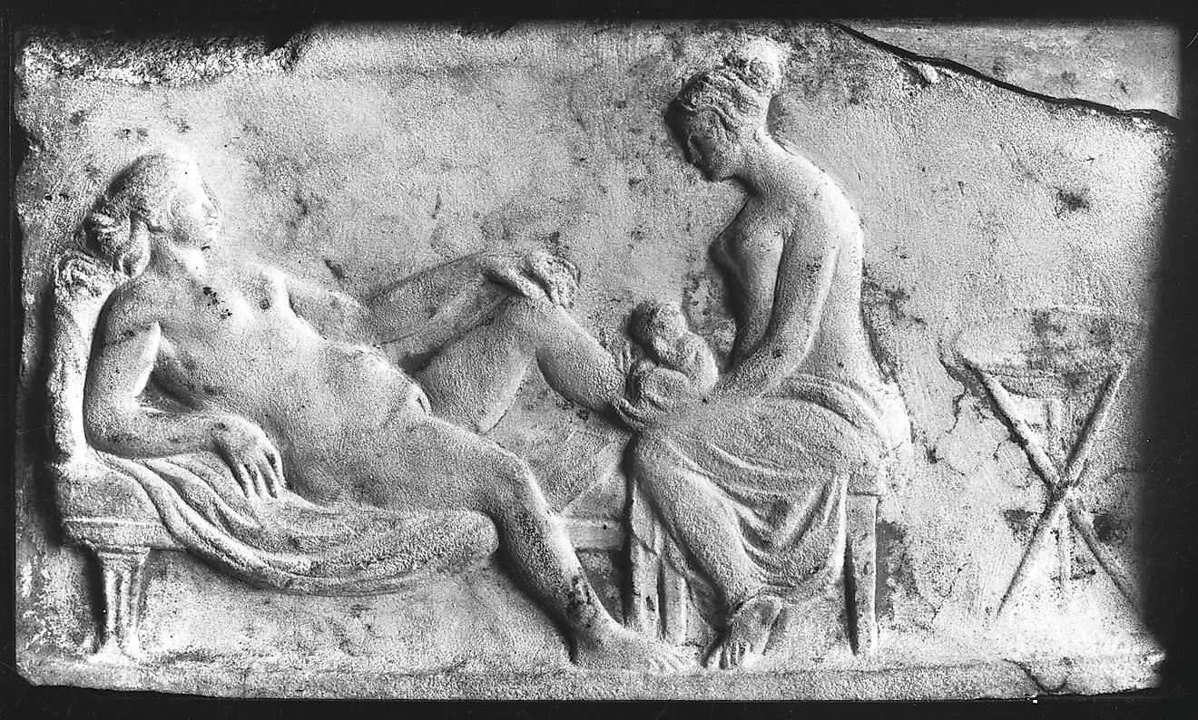 Ancient Roman carving of a midwife. Image by Wellcome Images. CC BY 4.0 <https://creativecommons.org/licenses/by/4.0>, via Wikimedia Commons
