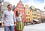 Smiling couple in Sweden's Stortorget Square in Gamla Stan. 